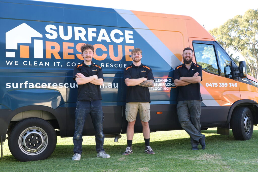 Team members of an Adelaide resurfacing company stand by their service van.