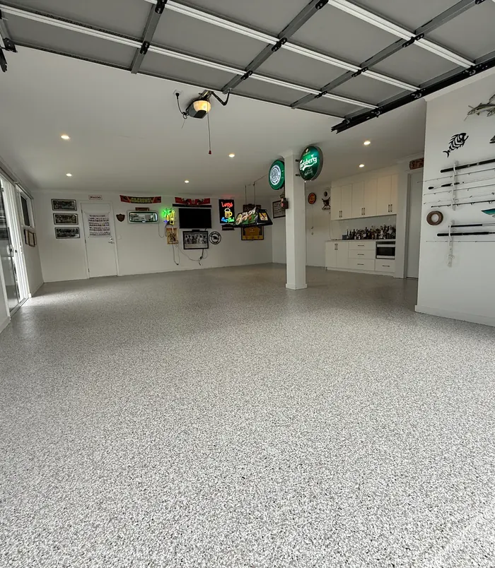 Glossy epoxy garage floor in a workshop with memorabilia on the walls