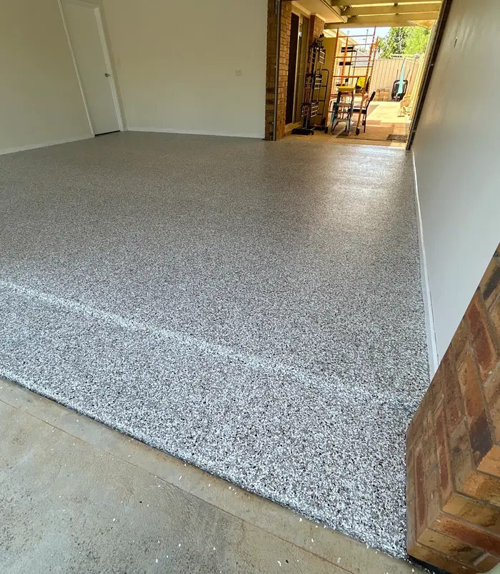 Grey speckled epoxy flake garage floor with a clean, uniform finish
