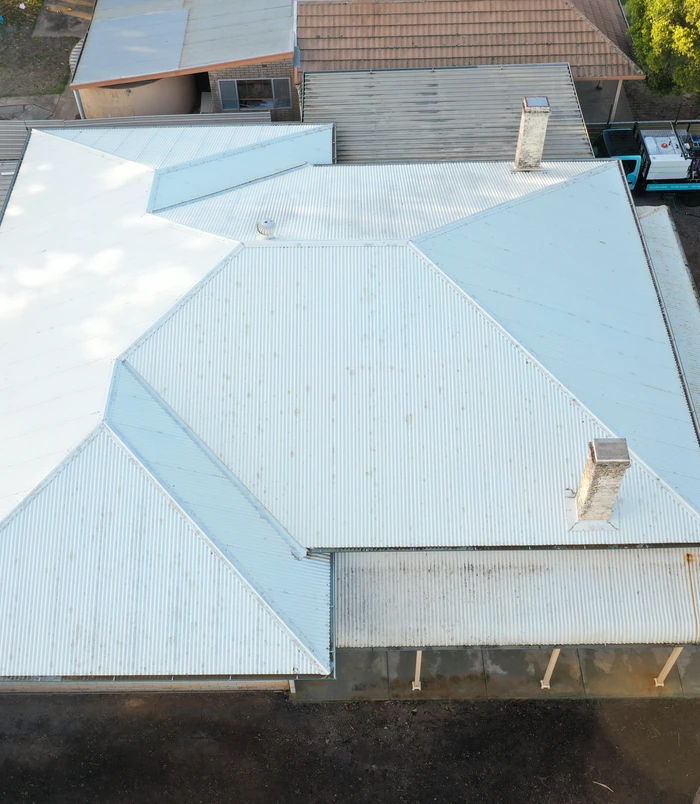 Clean, light blue-grey roof viewed from above after pressure washing