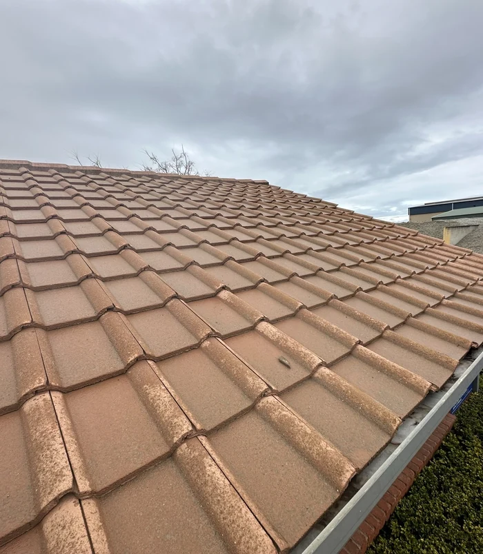 Clean terracotta roof tiles with an even, warm colour after pressure washing