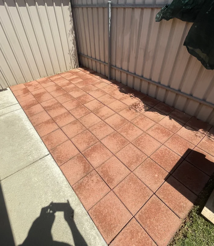 Clean square pavers with a bright terracotta colour in a courtyard after pressure washing