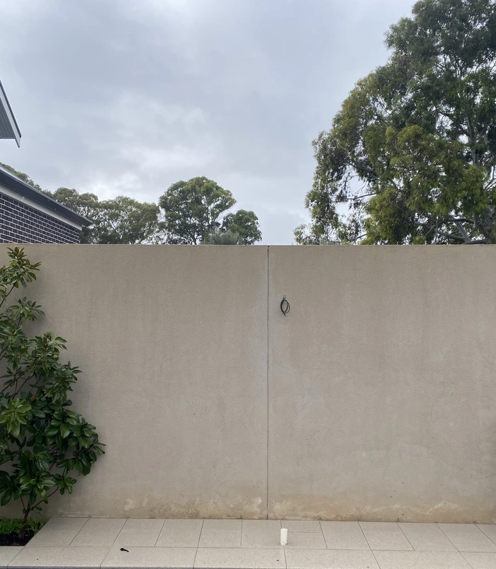 Clean, even-coloured rendered boundary wall after pressure washing