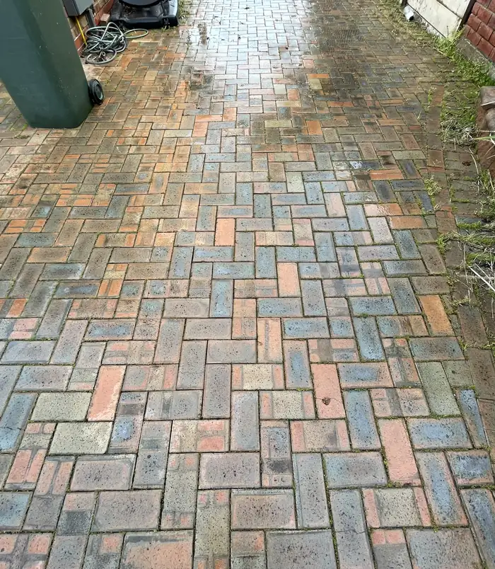 Clean brick paver path with bright, restored colour after pressure washing