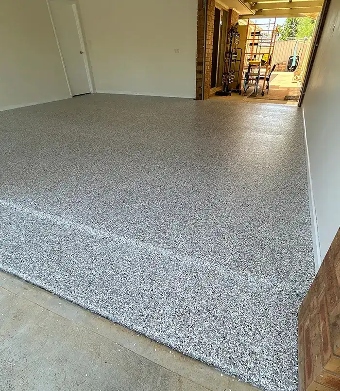Grey speckled epoxy flake garage floor with a clean, even finish