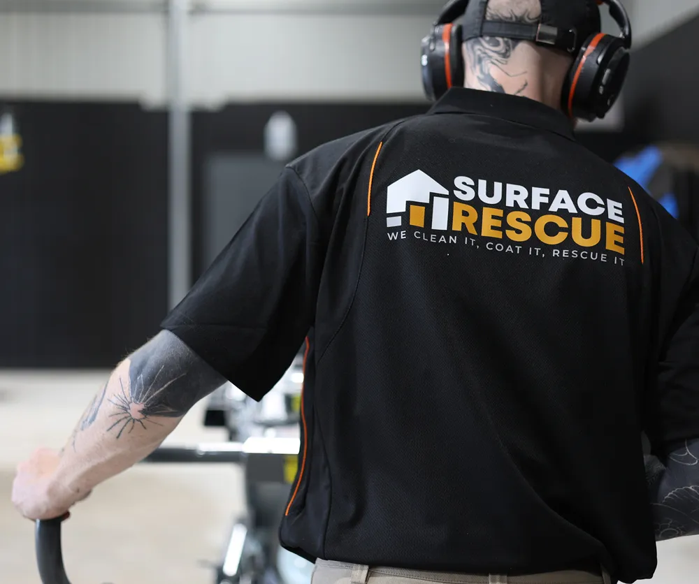 Back view of a Surface Rescue technician in a black branded shirt and ear protection