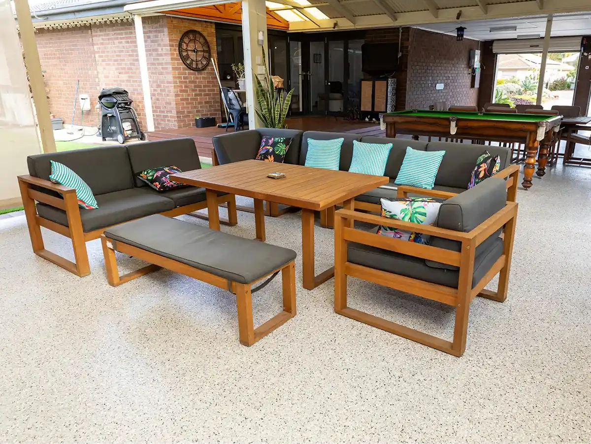 Covered outdoor entertaining area with timber dining table, lounge seating and pool table