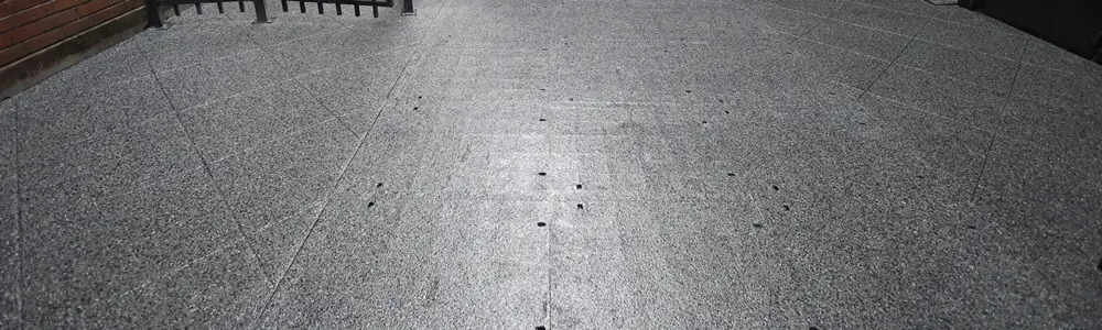 Close-up of a grey concrete floor with a smooth, mottled finish