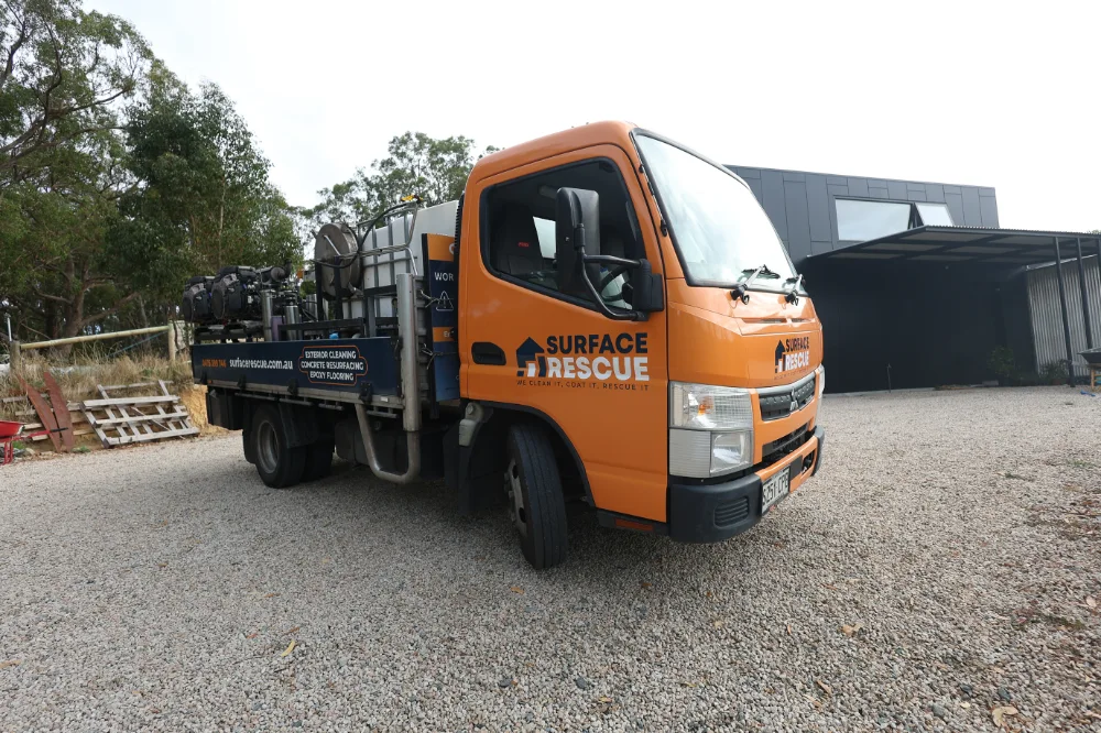 Orange Surface Rescue service truck carrying pressure washing equipment