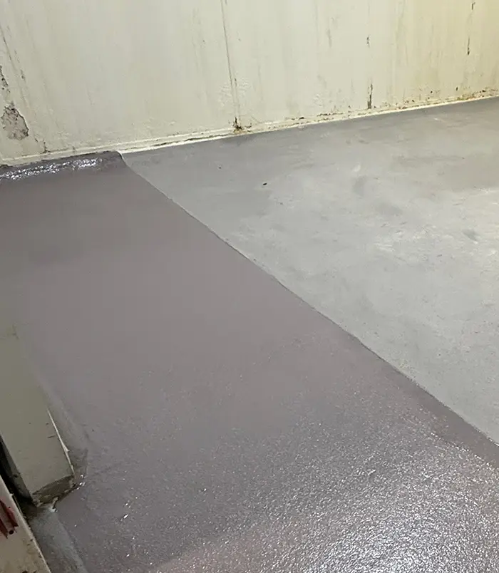 Smooth grey epoxy floor coating applied across an industrial space